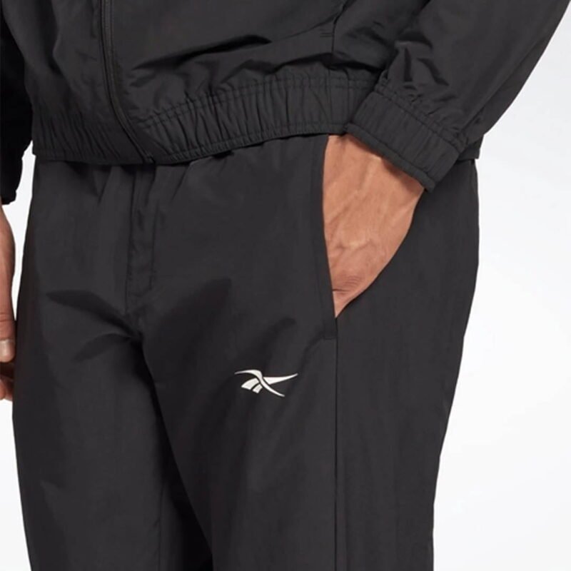 Une personne porte un costume à la mode avec un haut de robe décontracté comportant une poche, des boutons et des manches en tissu.